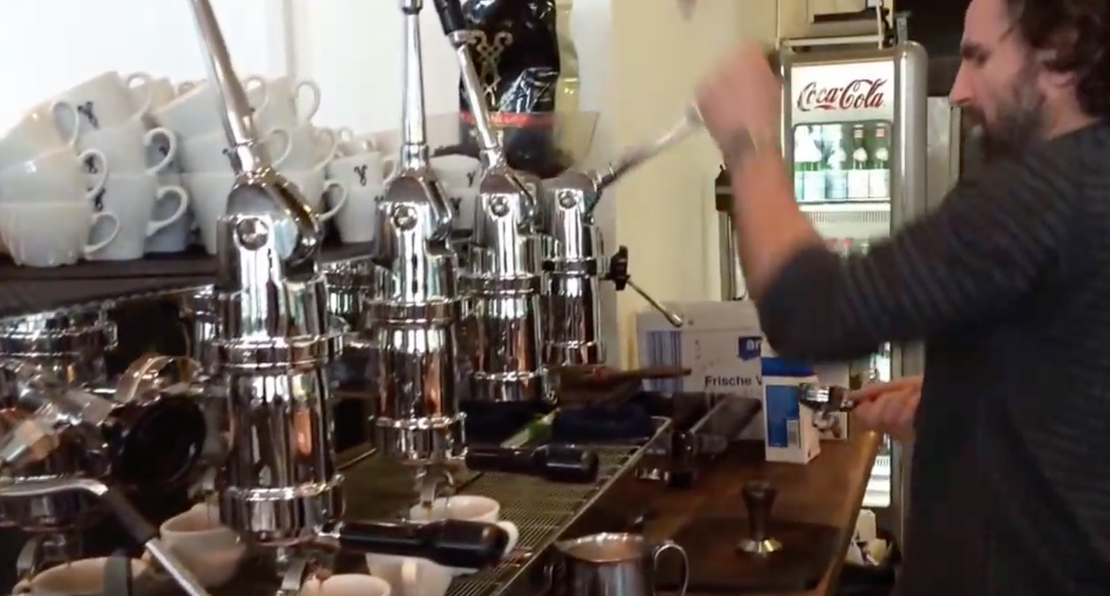 Barista Dritan Alsela with his 4 group lever machine.