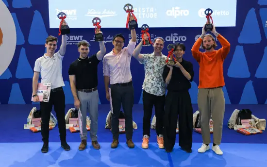 The top 6 competitors at the WBC hold up their trophies above their heads.